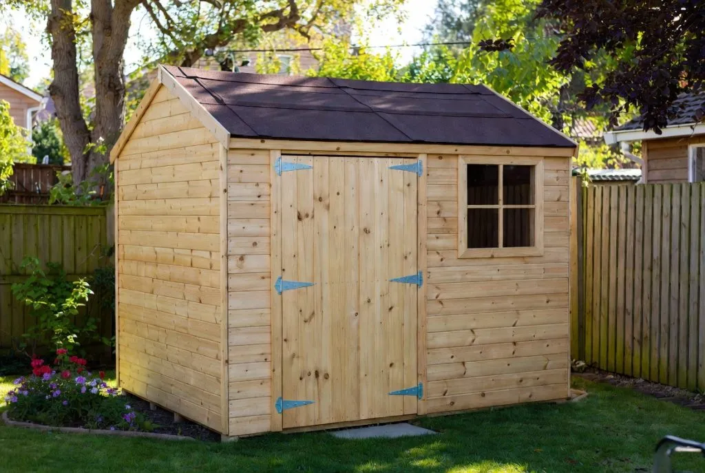 A timber garden shed and fence from the Lands Timber Solutions site.